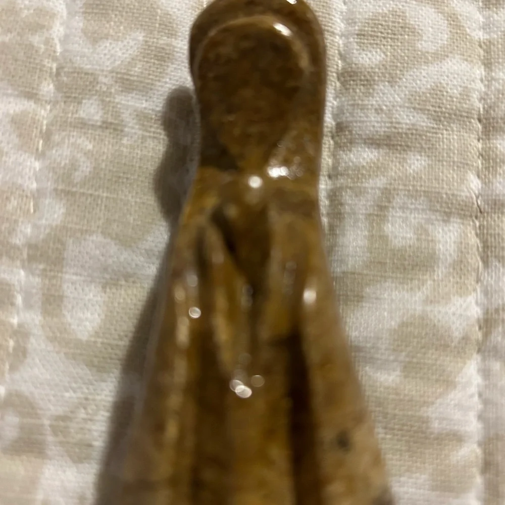 Carved stone figurine, praying Virgin Mary.